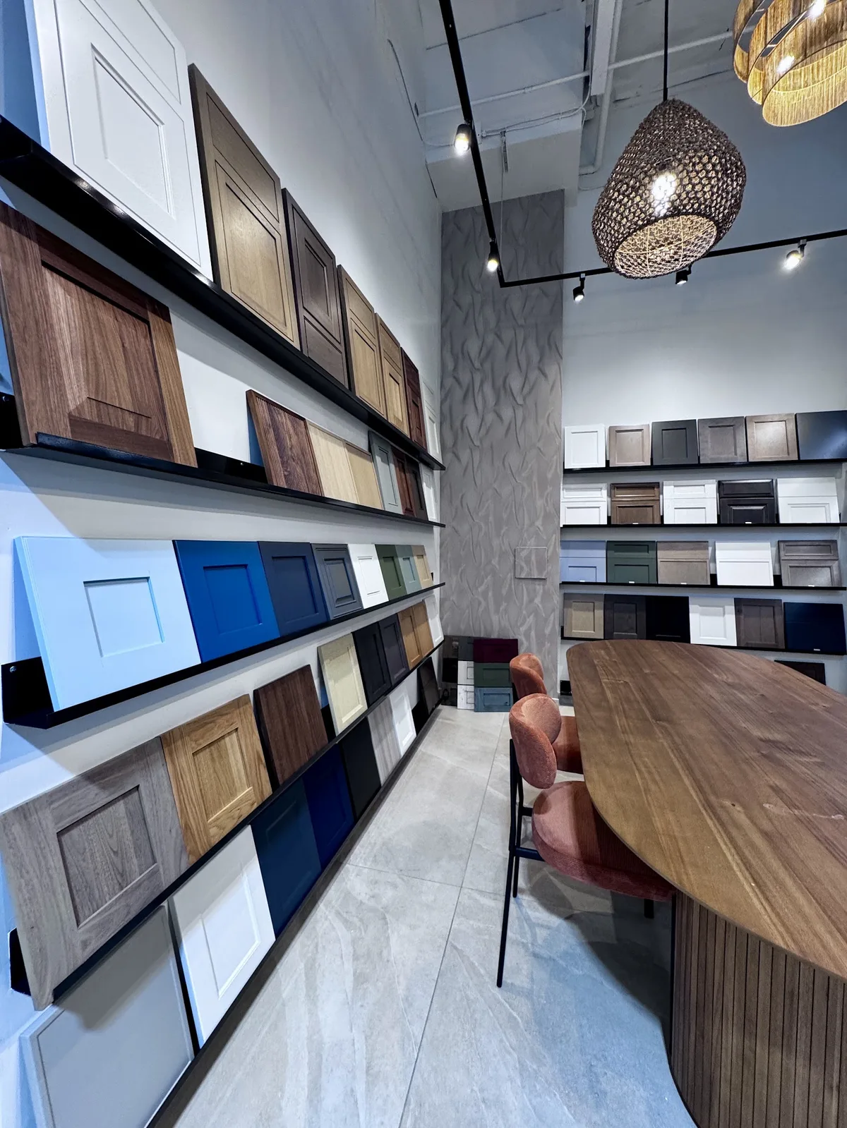 Wall of custom slab-style cabinet door and drawer-front samples at the Modern Concepts Design showroom